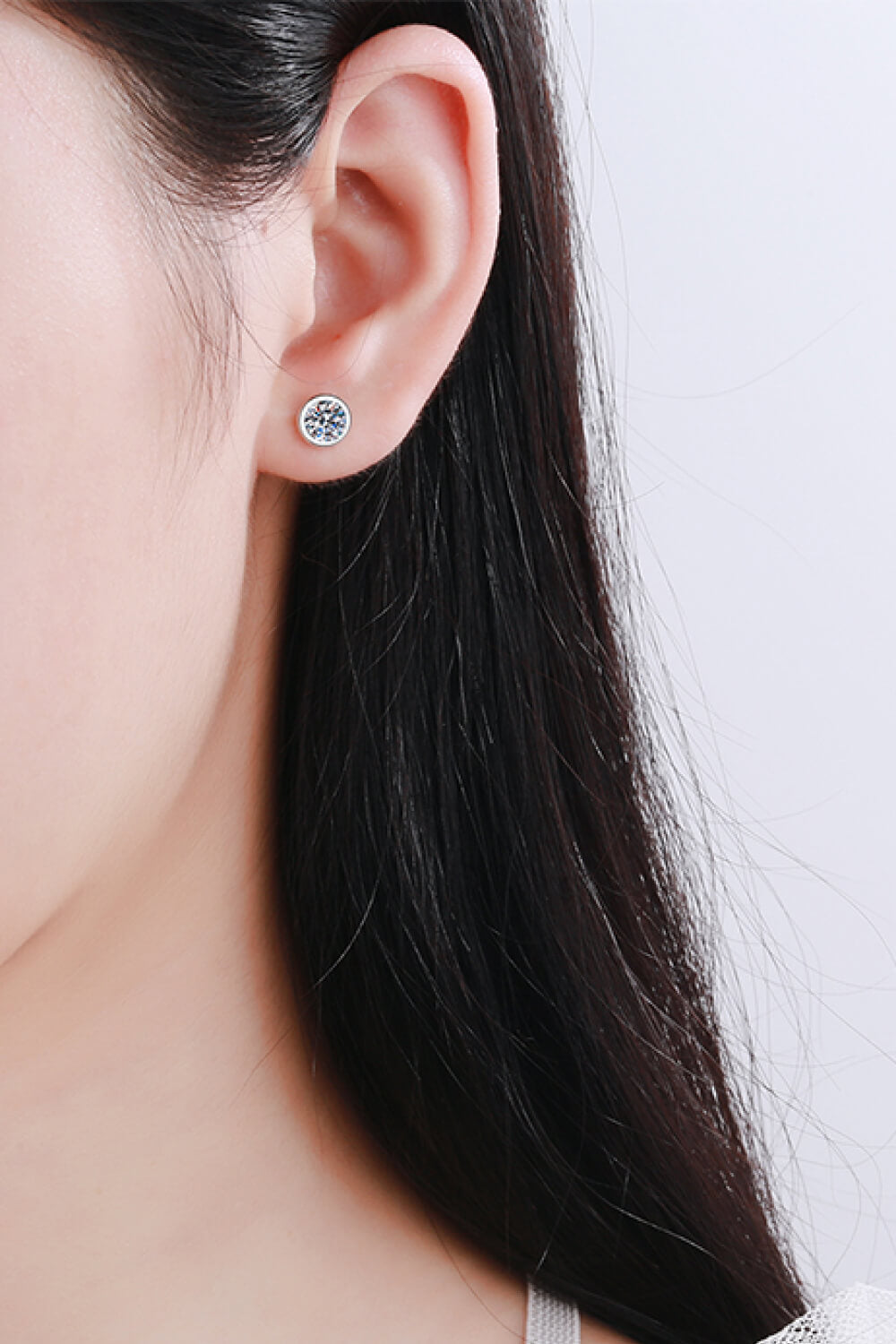 Moissanite Round-Shaped Stud Earrings shown in ear