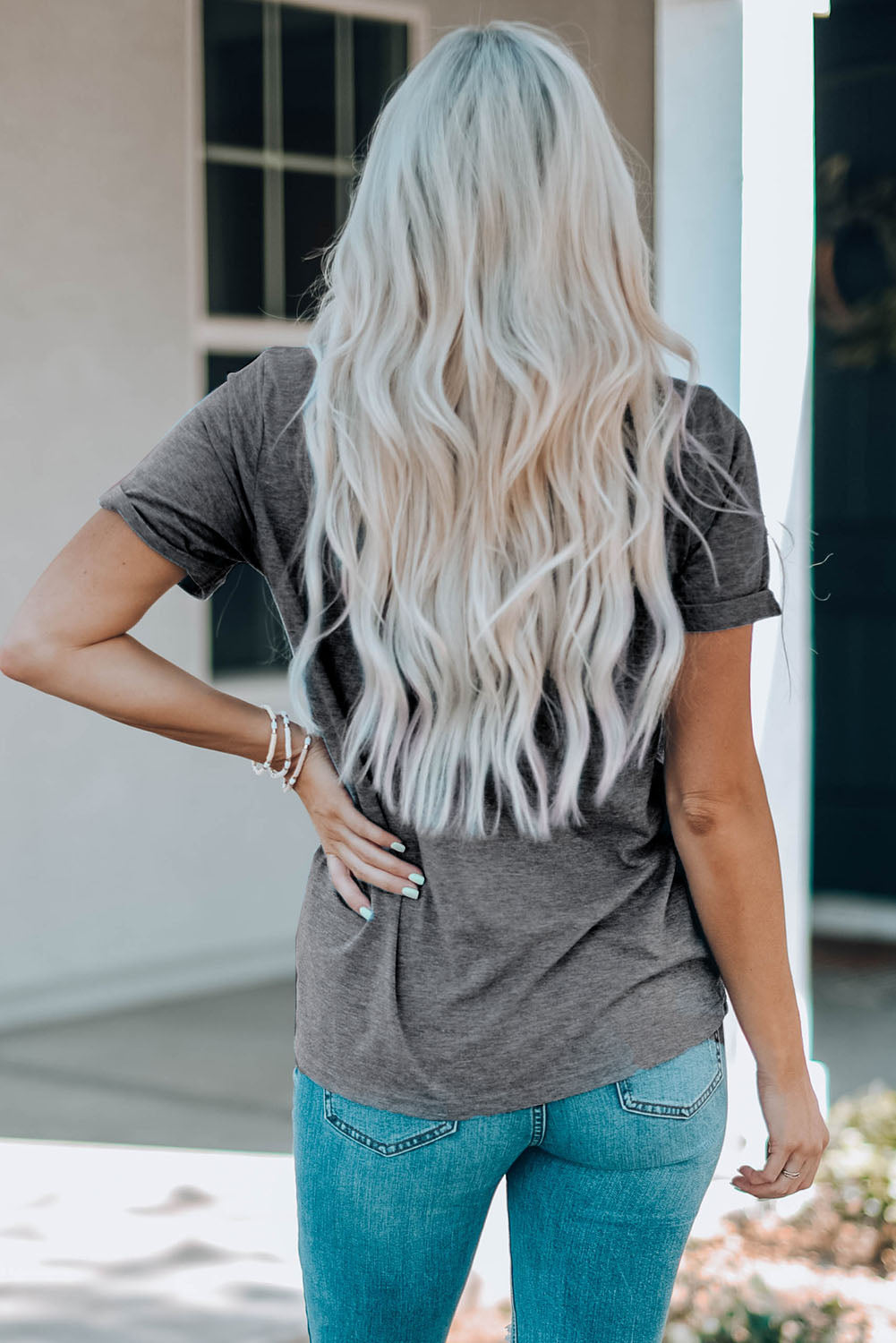 bold cow skull graphic on a gray round necked tshirt back view